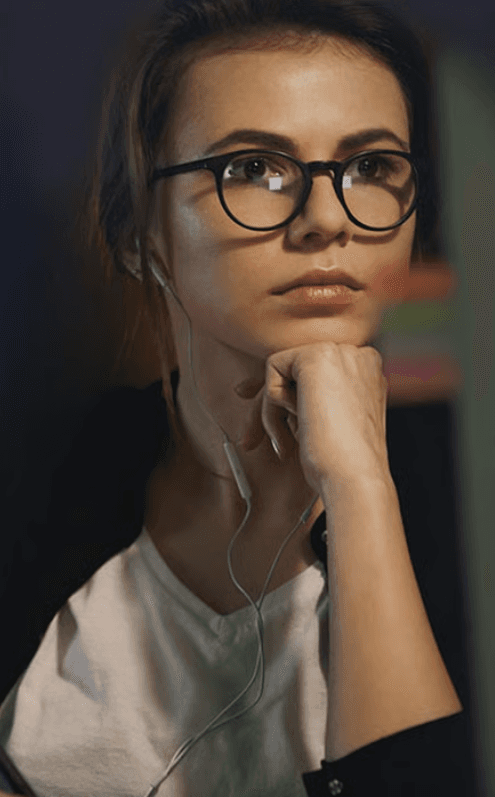 Student deep in a self-paced AI lab, earphones in, working through a module
